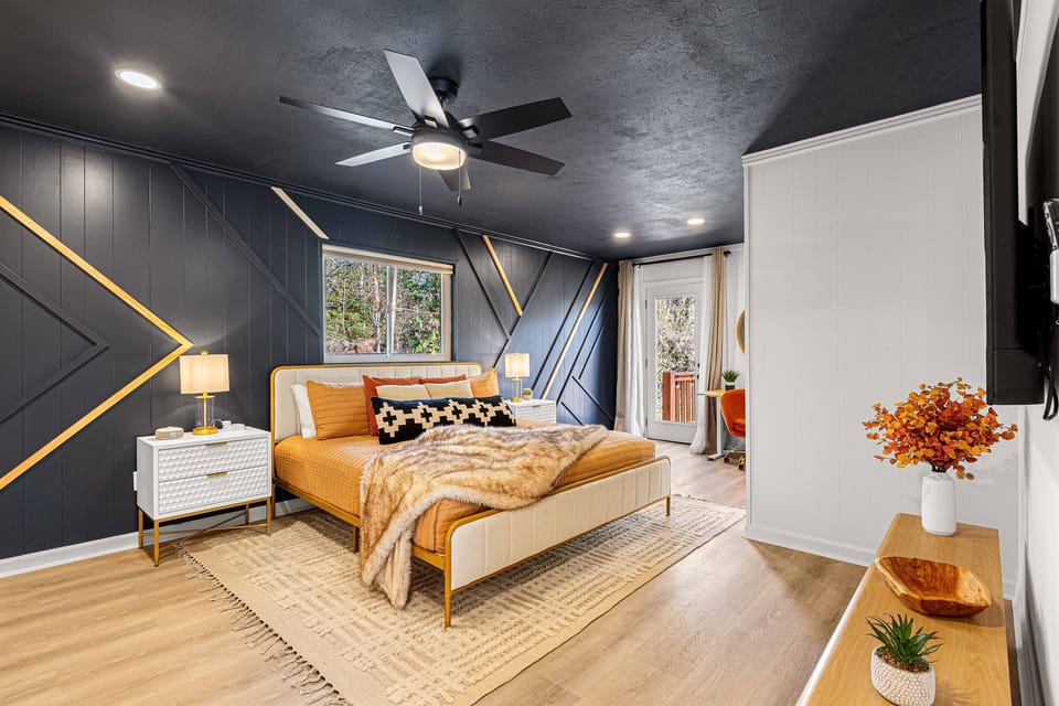 Spacious bedroom with soft tones and cozy bedding.
