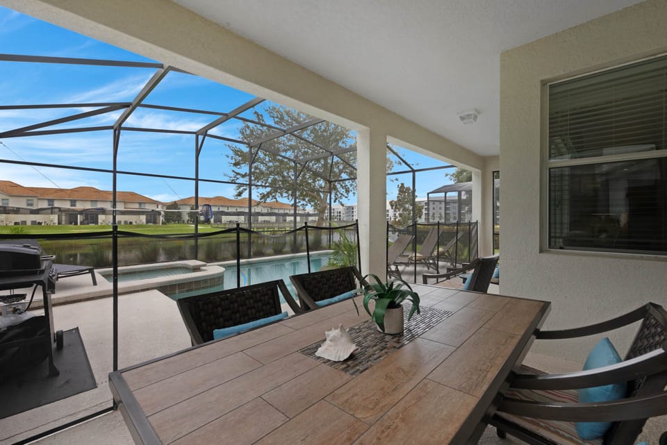 The sliding glass door opens to a covered, screened patio with dining for 6 