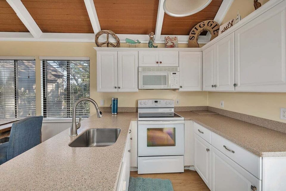 Kitchen with white appliances, cabinets, and granite countertops