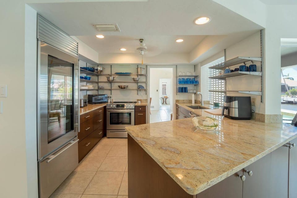 The kitchen features granite counters and stainless appliances.
