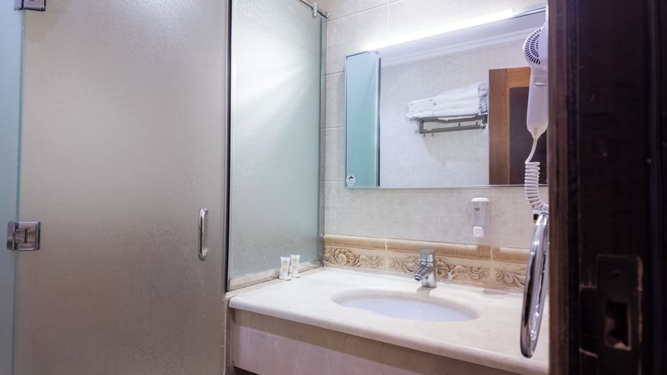 Shower, hair dryer, slippers, towels