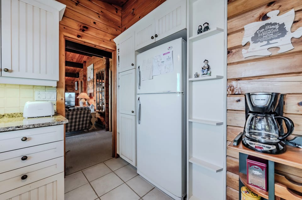 The kitchen blends modern convenience with rustic charm, featuring updated appliances and thoughtful touches. A welcoming space to prepare meals before heading out to hike the Bruce Trail.