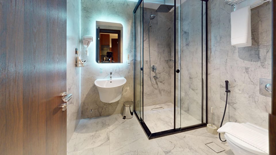 Designer toiletries, hair dryer, slippers, bidet