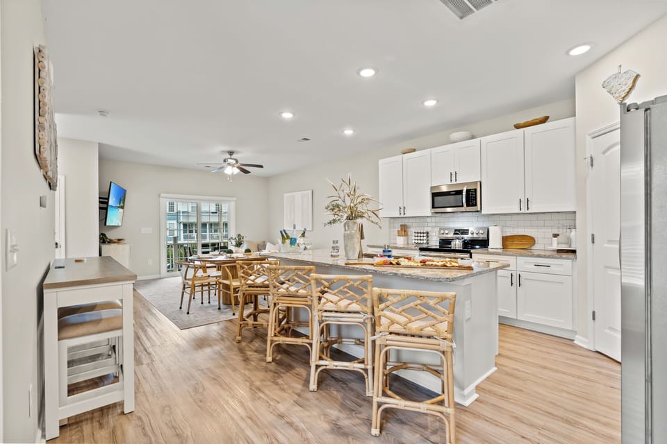 Kitchen island seating for 4 and 3 more at the wall table
