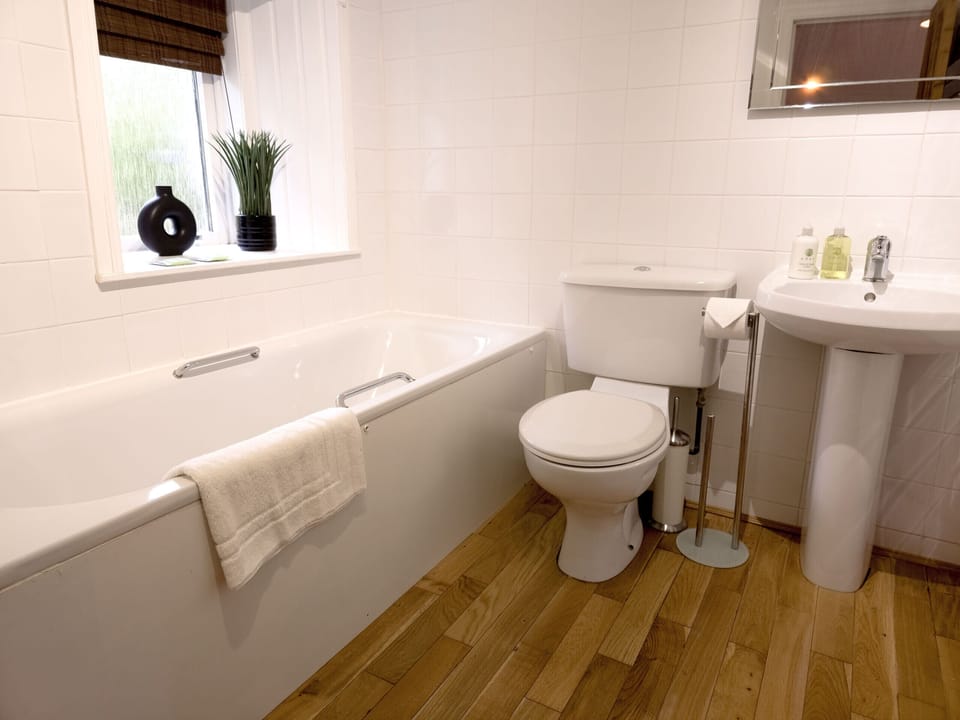 A clean and modern bathroom with a walk-in shower and bath
