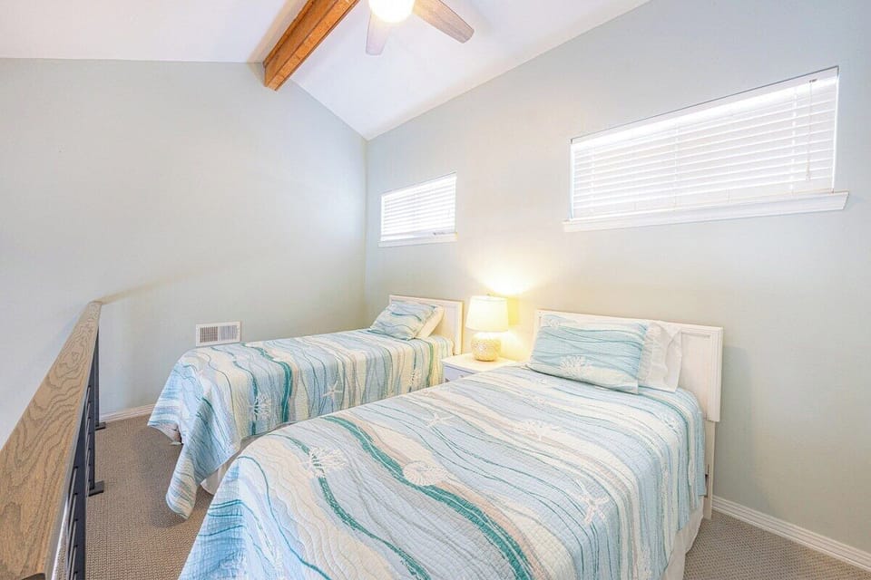 2 twin beds overlooking primary living area