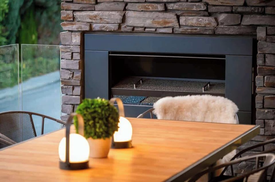 Scenic Outdoor Dining Area with Gas Fireplace
Enjoy meals on the outdoor dining table while taking in breathtaking lake and mountain views, with the comfort of a gas fireplace to enhance your experience.