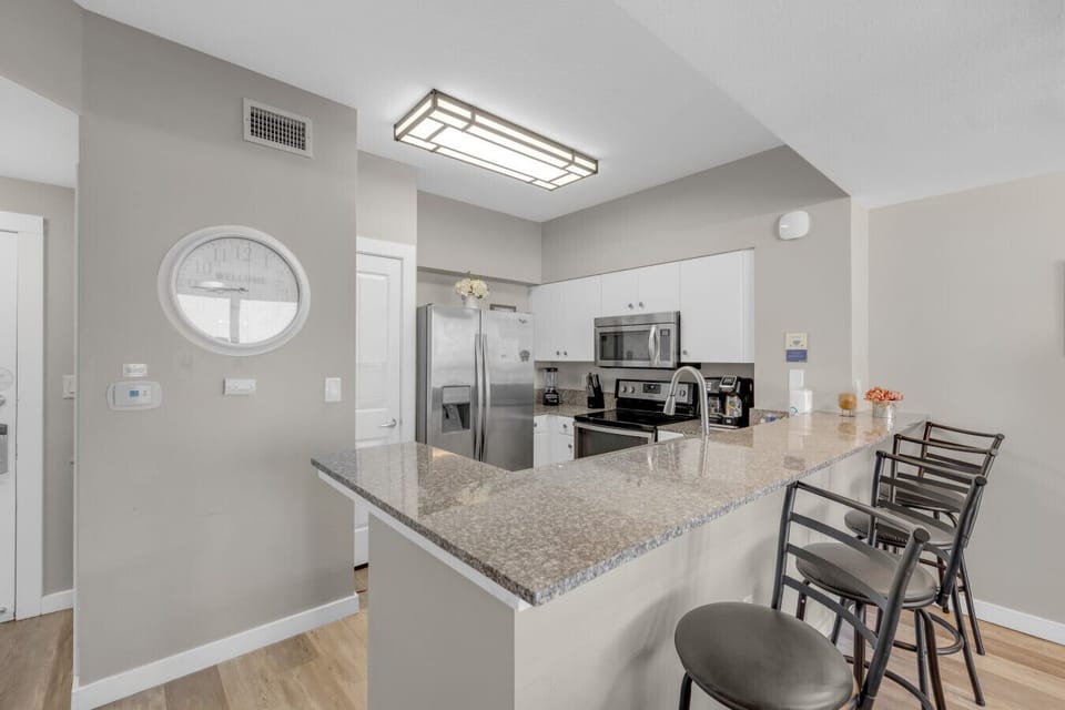 Cook up your favorite meals in the fully equipped kitchen featuring modern appliances and a granite breakfast bar.