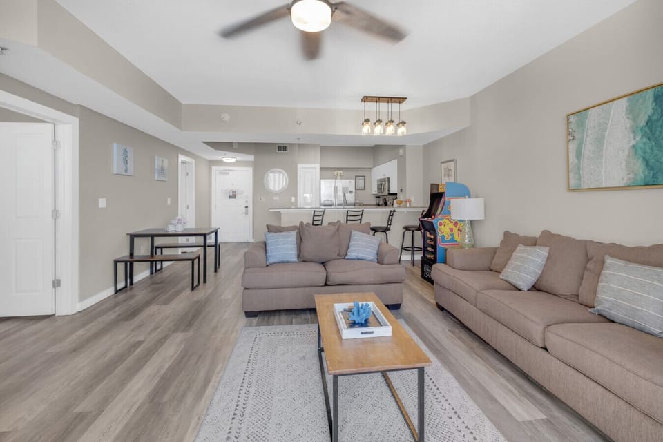 Relax in the spacious living room with a queen-size sleeper sofa and a charming arcade game for entertainment.