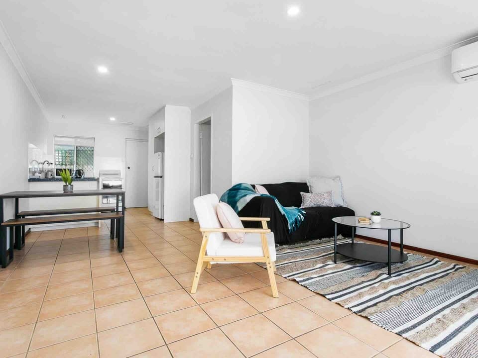 Comfort meets convenience in this bright living area, flowing into the dining and kitchen zones.