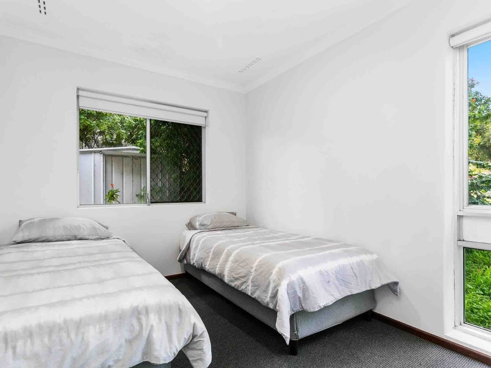 A peaceful space for a restful night's sleep, featuring individual beds and natural light.