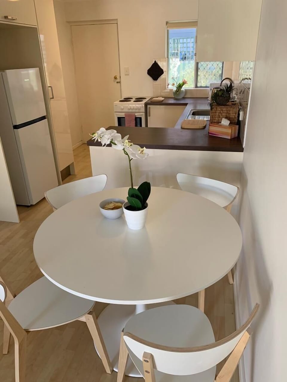Your cozy spot for dining, offering comfortable seating and easy access to the kitchen amenities. 