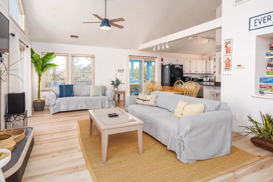 Cozy living area with TV, fully stocked board games and multiple deck access. 