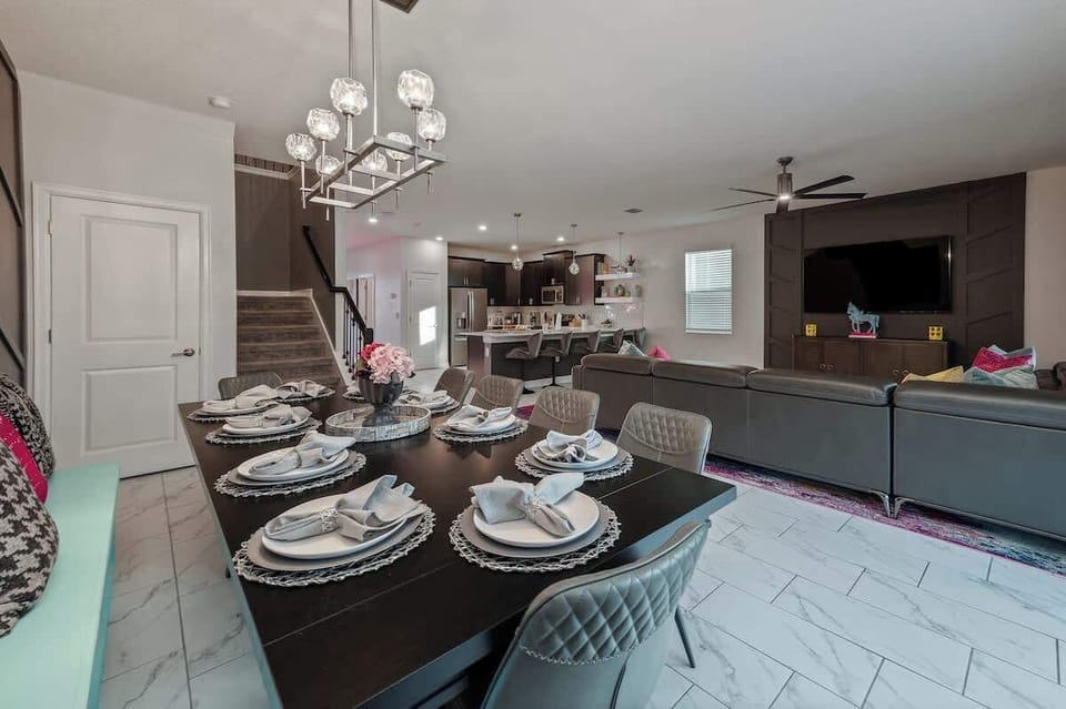 Dining table with seating for 10, plus high chair. Connected to down stairs living room and kitchen with spacious open floor plan. Stool seating at the counter, plenty of room for the whole family to be together!