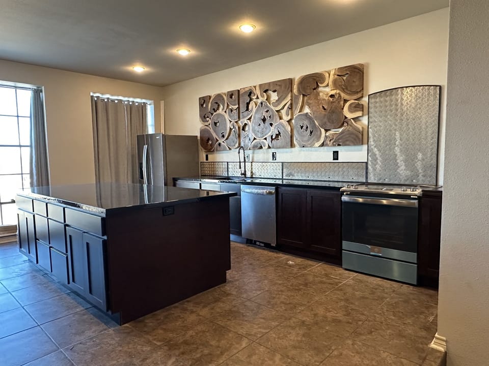 New cabinetry, countertop, and oven.  Backsplash crafted from aluminum plate from wind turbine flooring.