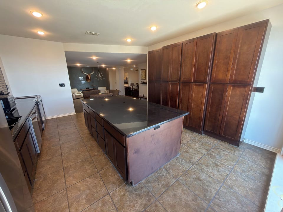 New cabinetry, sink, countertops, and oven.