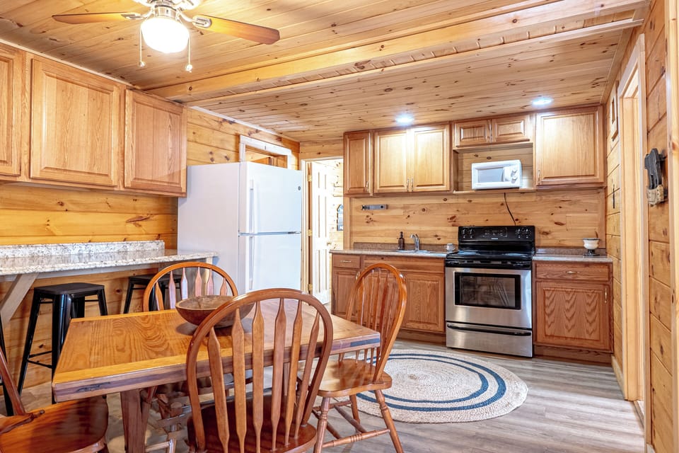 The main area includes a full kitchen with a dining table.