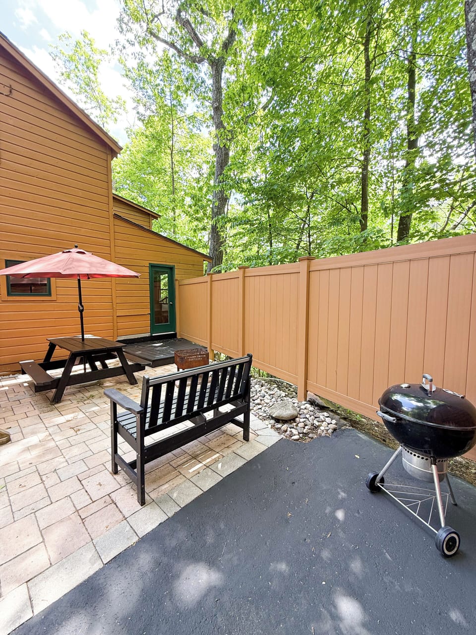 Patio located at the back of the home with a picnic table, BBQ grill and firepit