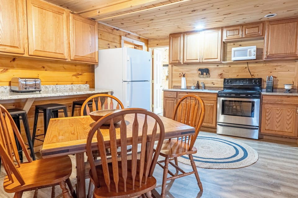 The main area includes a full kitchen with a dining table.