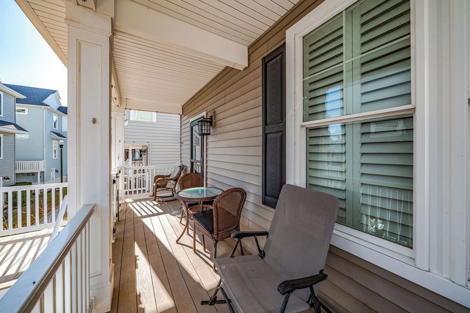 Covered balcony area with outdoor furniture
