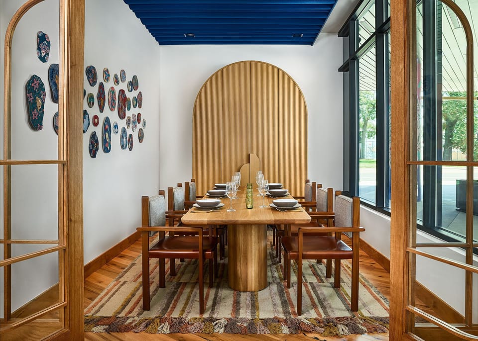 A refined setting with warm wood tones, contemporary decor, and ample natural light—perfect for intimate gatherings and thoughtful conversations.