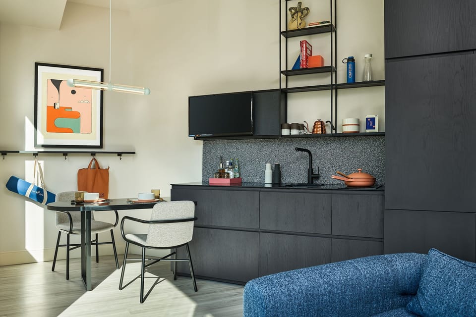 A well-equipped kitchenette paired with a stylish dining area, perfect for enjoying meals or unwinding with a drink.