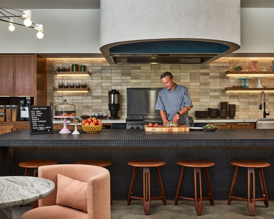 Experience the heart of hospitality in this open kitchen setting, where culinary creativity meets modern design in a vibrant and welcoming space.