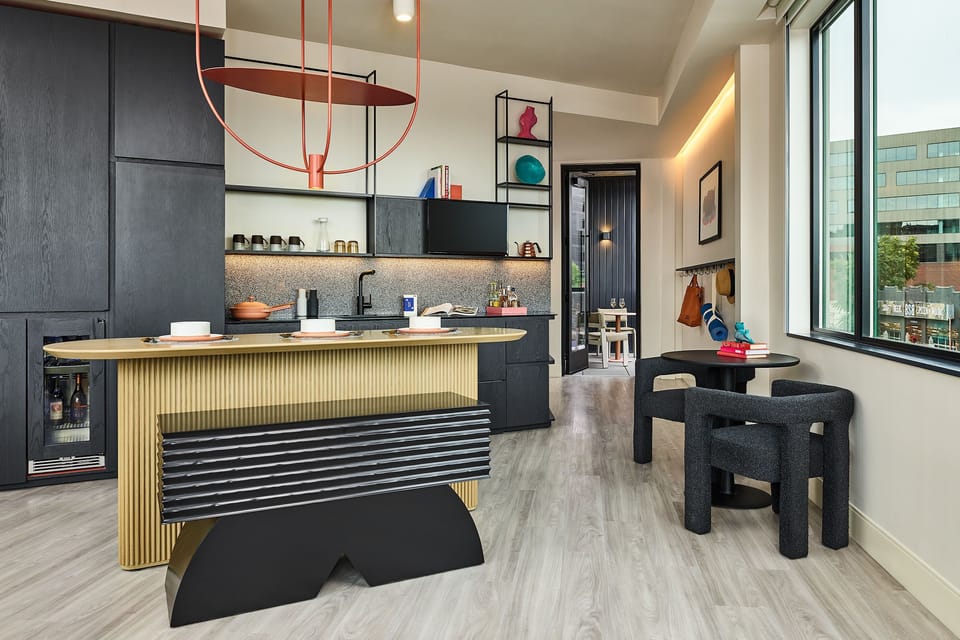 A thoughtfully designed dining and kitchen area, blending contemporary aesthetics with practical comfort for a seamless stay.