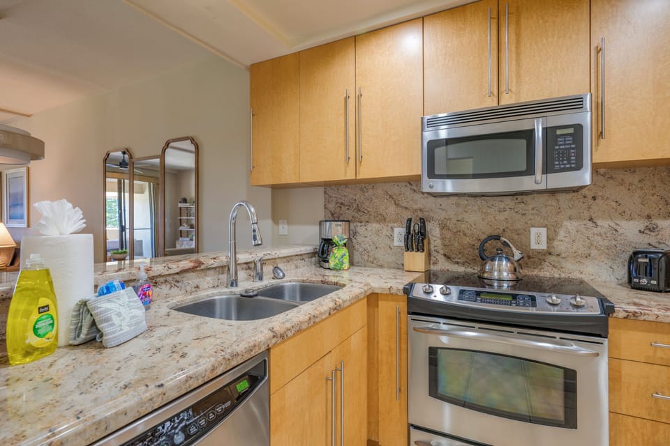Equipped with full-size stainless steel appliances, this kitchen makes cooking on vacation feel effortless.