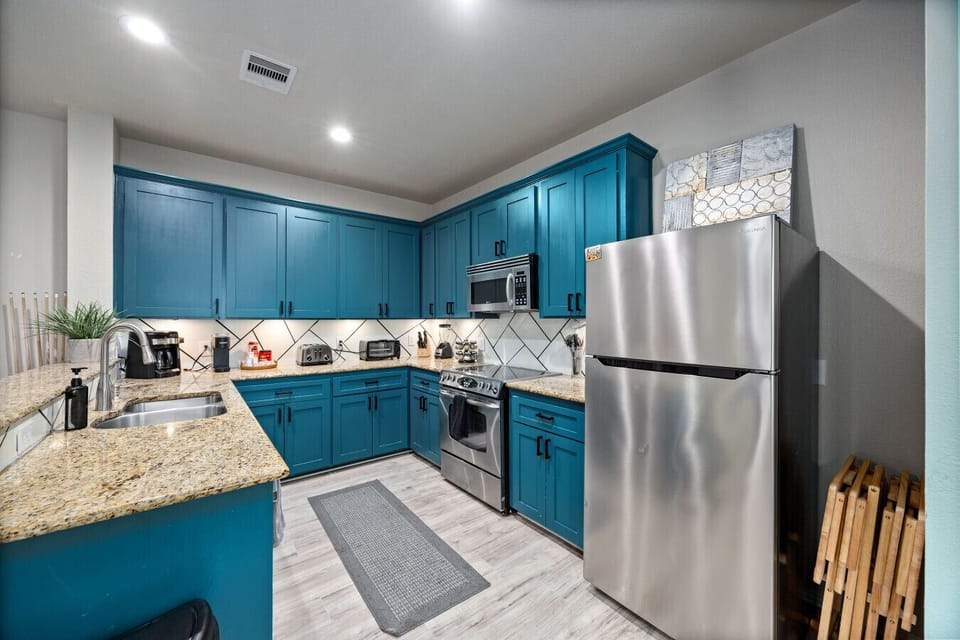 Fully equipped kitchen with granite countertops, stainless steel appliances, and ample prep space—everything you need for meals before concerts, conventions, or game day.