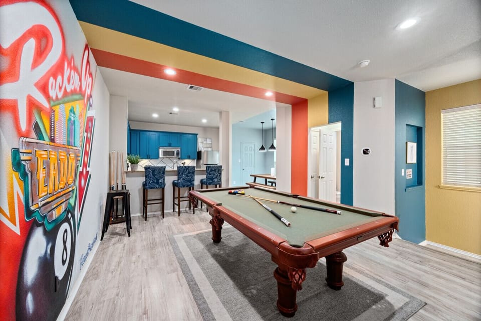Open entertainment space with pool table and bar seating—perfect for group gatherings before heading to nearby stadiums and nightlife.