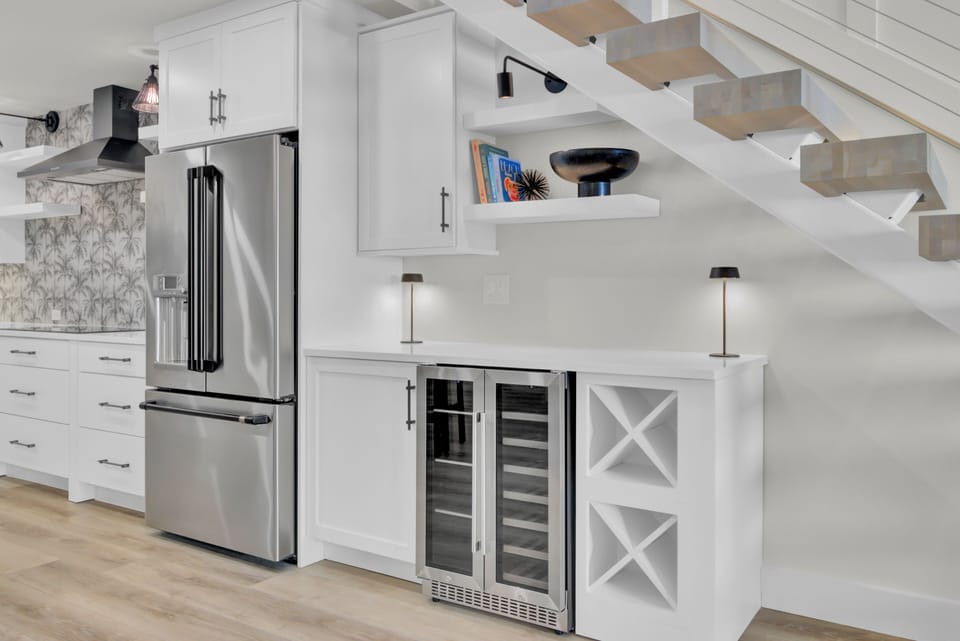 Spacious kitchen with a large fridge and a wine cooler for all your essentials.