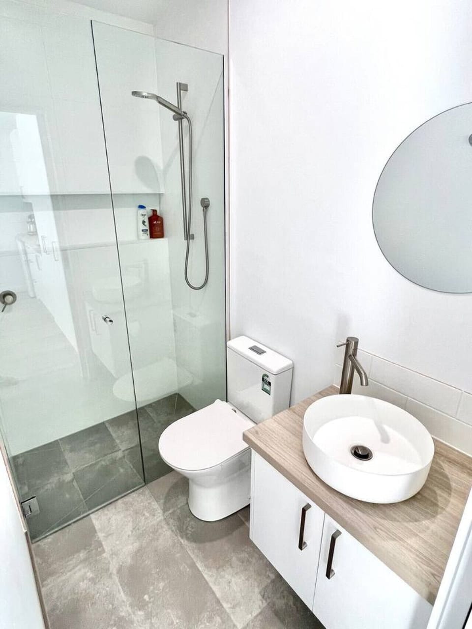 Bright modern bathroom with glass shower and stylish vanity