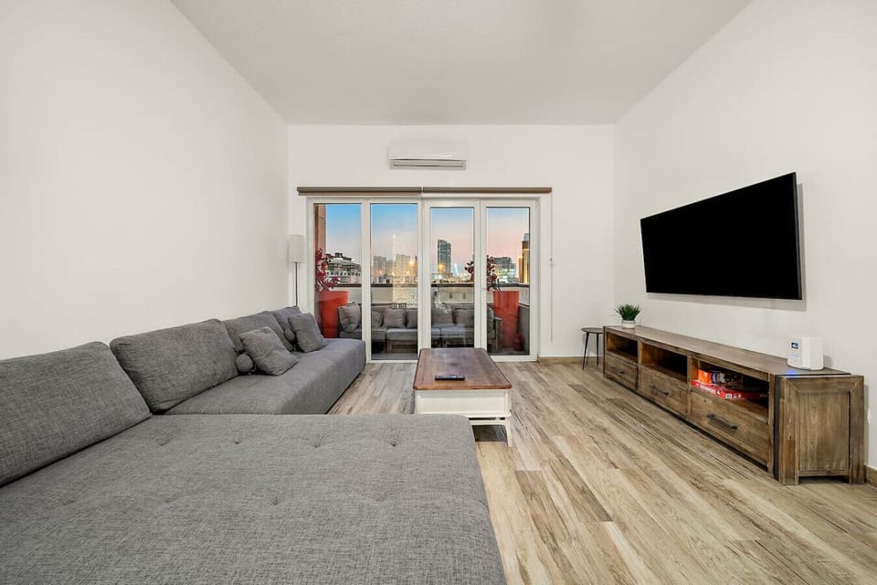 Living Room: Bright space with city views, plush seating, and modern decor for ultimate relaxation!
