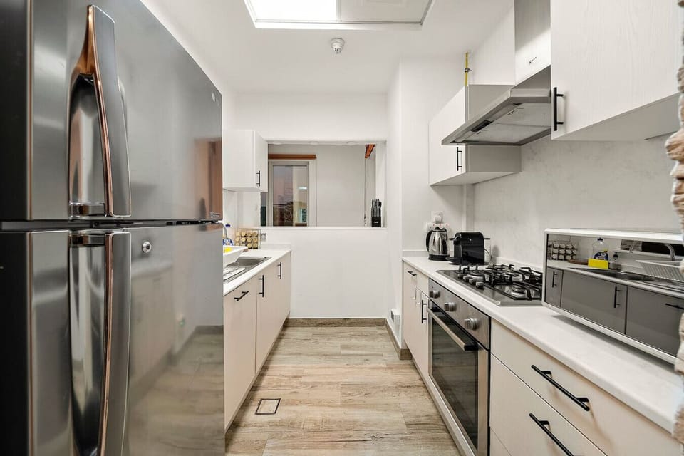 Modern Kitchen: Cook up a storm in this sleek, fully-equipped space with plenty of natural light!