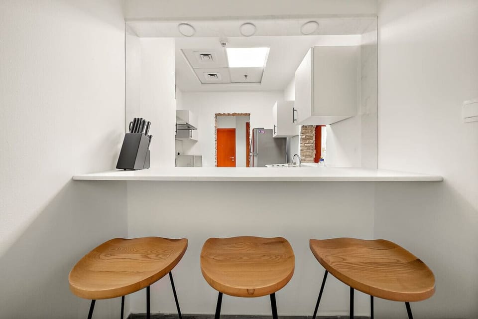 Kitchen Nook: Sleek countertop and modern stools perfect for casual dining or morning coffee!