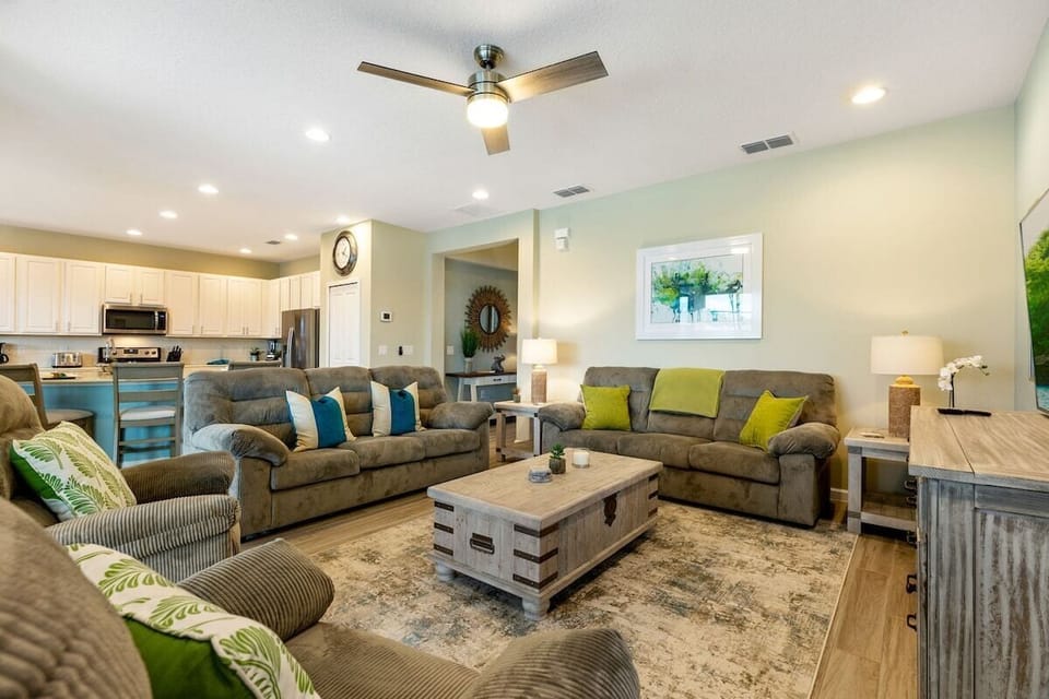 Picture an inviting open-plan family living room that is thoughtfully designed to provide the ultimate space for relaxation, connection, and unwinding after an exciting day at Disney
