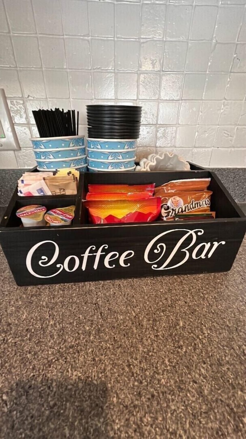 At the heart of the coffee bar is a sleek and modern espresso machine, complemented by a range of high-quality equipment, including a coffee grinder.