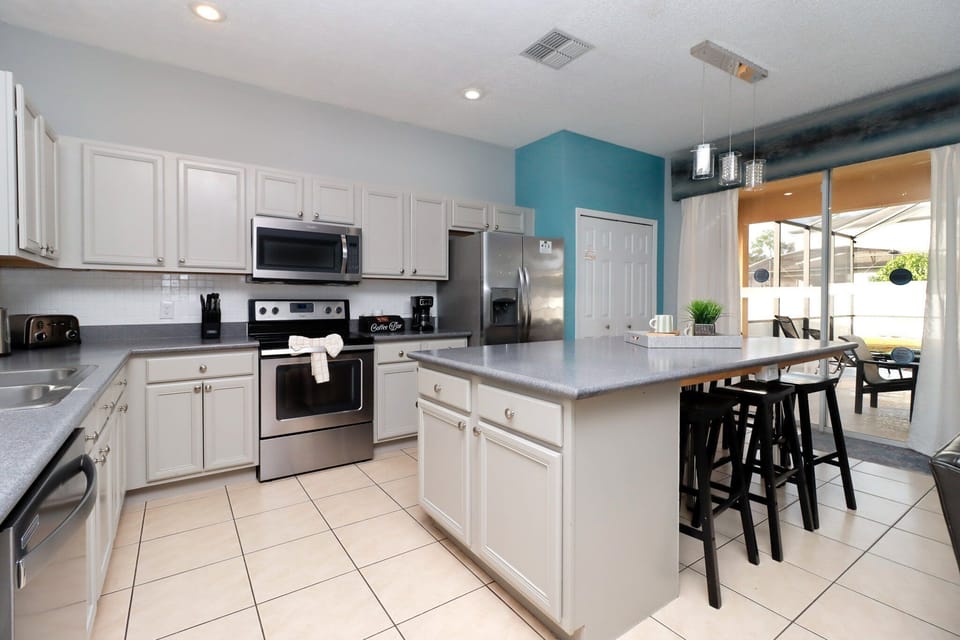 At the heart of the villa is a modern, fully equipped kitchen with all the appliances and gadgets you'll need. Prepare delicious family meals, enjoy quick breakfasts at the island bar, or serve snacks and drinks with ease throughout the day.