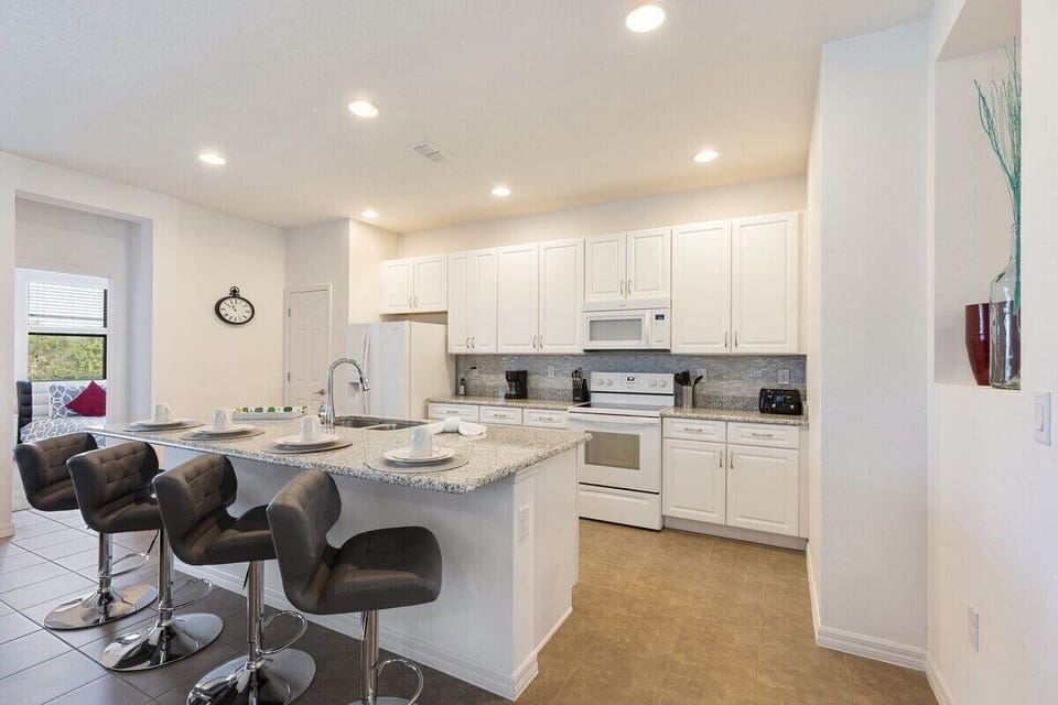 Ample counter space, including a spacious island in the center, makes meal preparation easy and efficient.