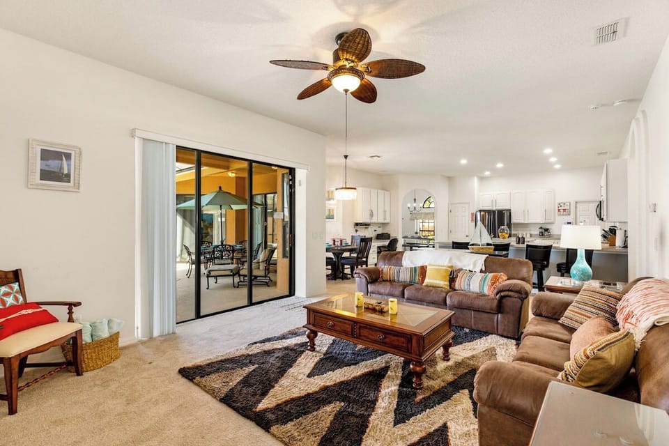 Bright, open-plan lounge with comfy seating & TV.