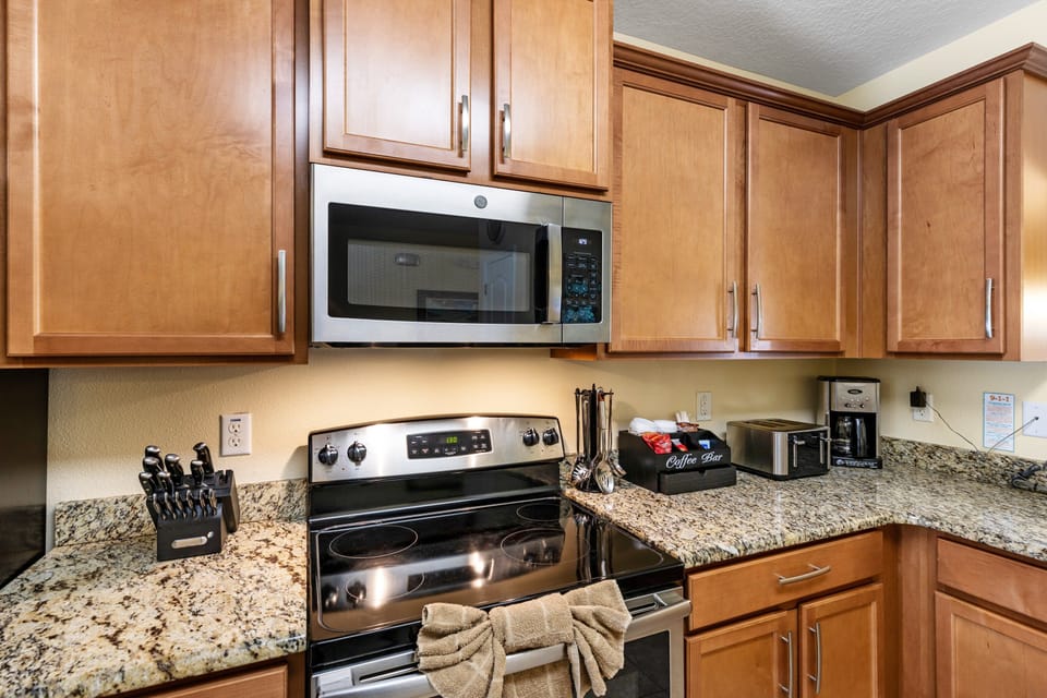 The wide island serves as both a prep area and a casual dining spot, perfect for quick breakfasts or entertaining guests while you cook.