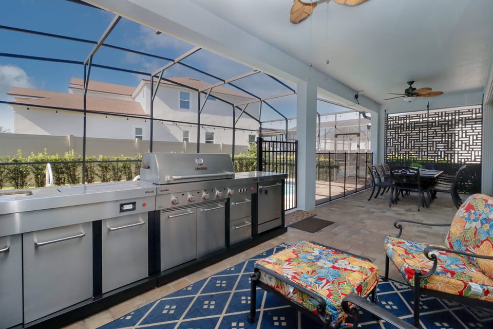 Enjoy a full outdoor kitchen with grill, sink, and fridge, plus a screened patio for privacy. The hot tub features a support rail for easy access. Want pool heat? Just let White Rose Villas know when booking!