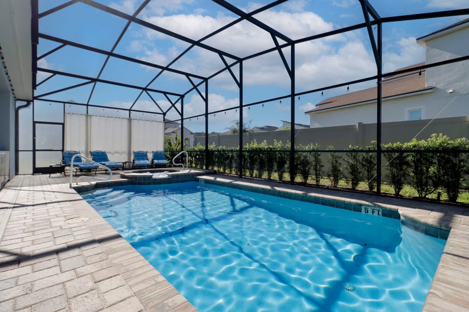 Enjoy a full outdoor kitchen with grill, sink, and fridge, plus a screened patio for privacy. The hot tub features a support rail for easy access. Want pool heat? Just let White Rose Villas know when booking!