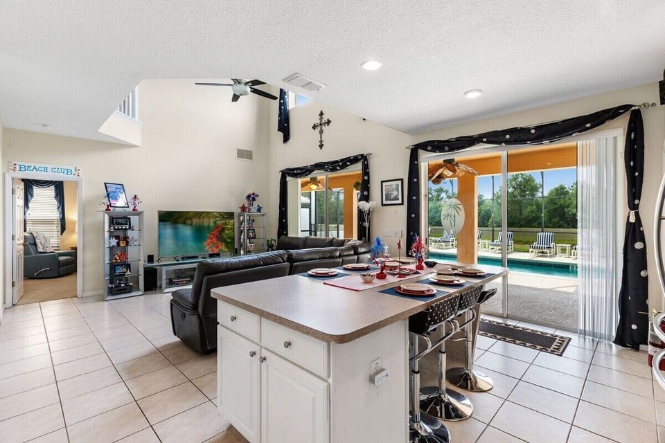 Large updated kitchen with stainless steel appliances and breakfast bar seating for 6