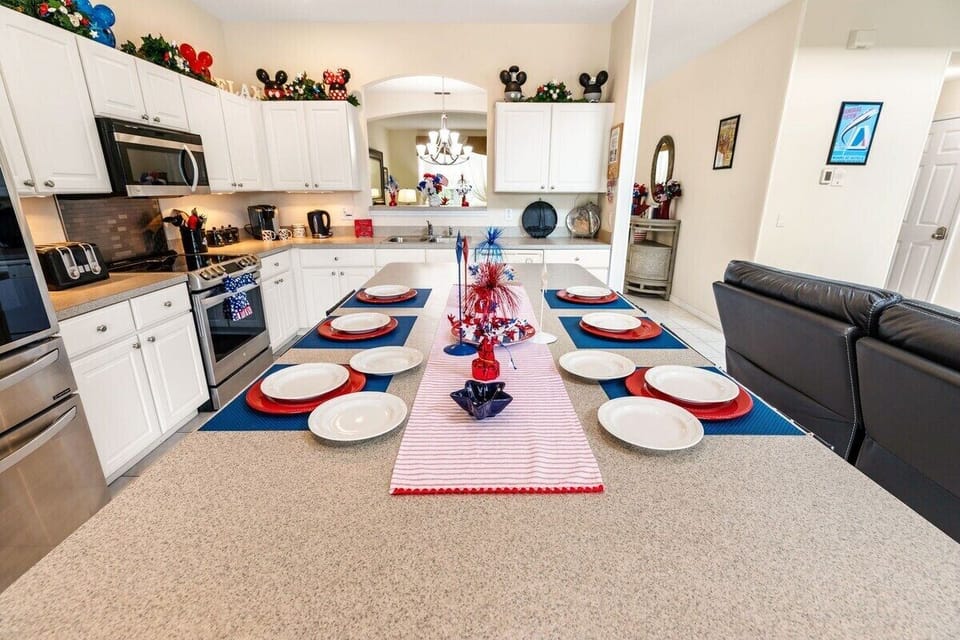 Large updated kitchen with stainless steel appliances and breakfast bar seating for 6