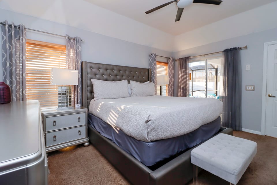 This grand bedroom exudes a perfect balance of style and relaxation, offering an expansive layout that allows for a variety of personalized touches and functional uses.