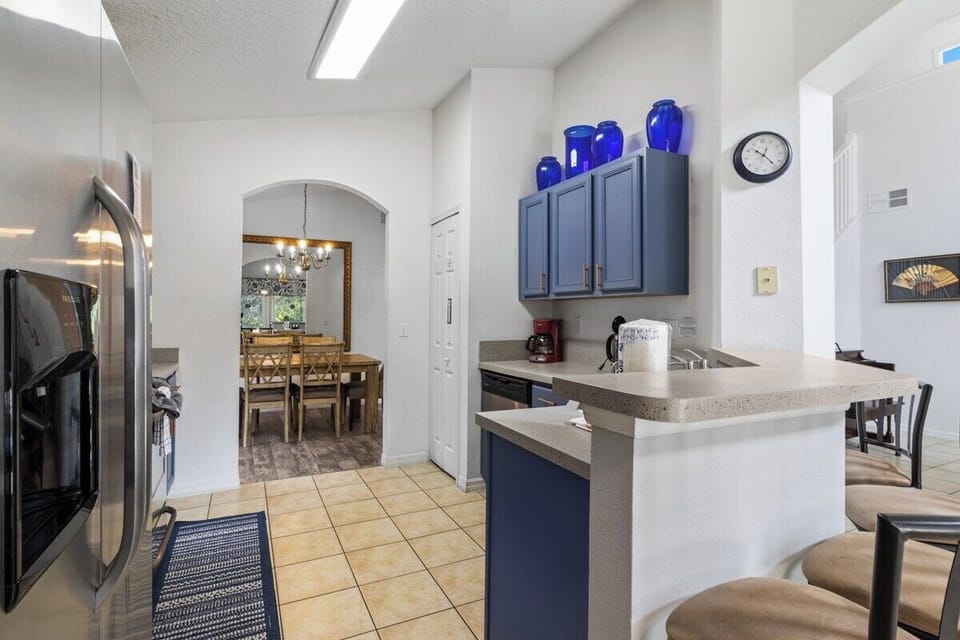 The open-plan kitchen with breakfast bar seating is a stunning, resort-style space that seamlessly blends functionality with elegance.