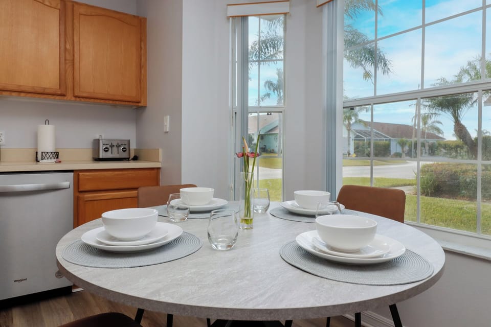 Experience the perfect blend of elegance and relaxation with an exquisite dining setup for four, bathed in the warm glow of natural sunlight.