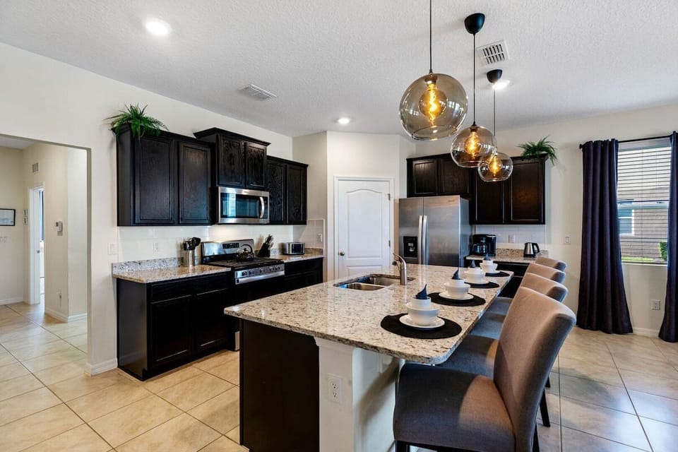 Welcome to a stylish and functional open kitchen that effortlessly combines contemporary design with practical convenience.